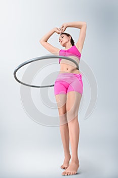 Young woman rotating hula hoop