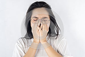 Young woman rubs her eyes after using glasses. Eye pain or fatigue concept