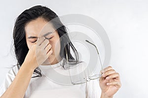 Young woman rubs her eyes after using glasses, touching eyelids, face with closed eyes, suffering from headache, weak eyesight,