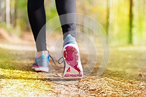 Young woman run in autumn the forest sunset lights