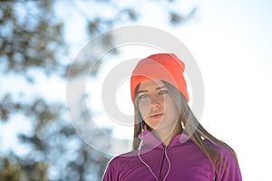 Young Woman Runner in Beautiful Winter Forest at Sunny Frosty Day. Active Lifestyle and Sport Concept.