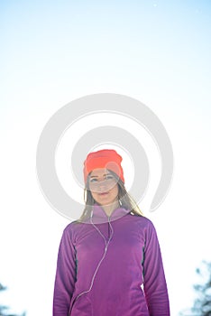 Young Woman Runner in Beautiful Winter Forest at Sunny Frosty Day. Active Lifestyle and Sport Concept.