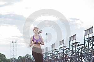 Young woman runner is jogging on the street be running for exercise.