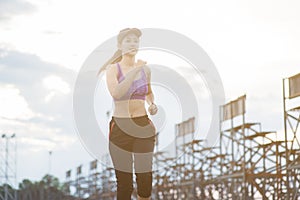 Young woman runner is jogging on the street be running for exercise.