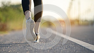 Young woman runner running on city bridge road, Young fitness woman runner athlete running at road