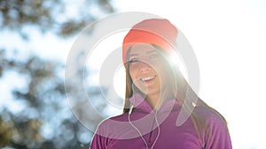 Young Woman Runner Smiling in Beautiful Winter Forest at Sunny Frosty Day. Active Lifestyle and Sport Concept.