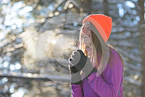 Young Woman Runner Smiling in Beautiful Winter Forest at Sunny Frosty Day. Active Lifestyle and Sport Concept.