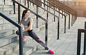 Young woman runner stretching before training