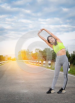 Young woman runner warm up outdoor. Healthy lifestyle and sport