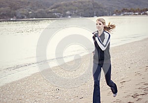 Young Woman running along the beach