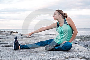 Young woman running away in an industrial scene, during sunrese.