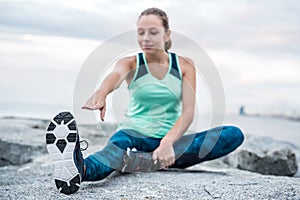 Young woman running away in an industrial scene, during sunrese.