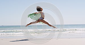 Young woman running at the beach 4k