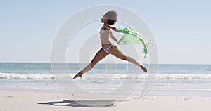 Young woman running at the beach 4k