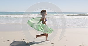 Young woman running at the beach 4k