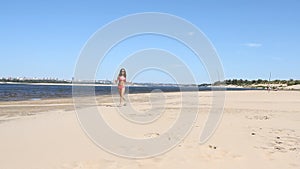 Young woman running on the beach