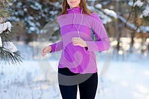 Young Woman Running in Beautiful Winter Forest at Sunny Frosty Day. Active Lifestyle Concept.