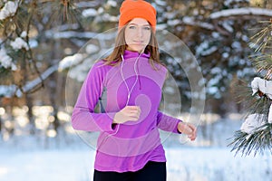 Young Woman Running in Beautiful Winter Forest at Sunny Frosty Day. Active Lifestyle Concept.