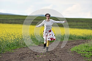 Young woman running on a countryside road. Freedom concept