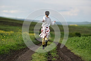 Young woman running on a countryside road