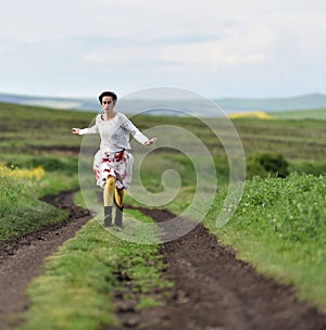 Young woman running on a countryside road. Freedom concept