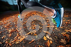 Young woman running in the early evening autumn leaves