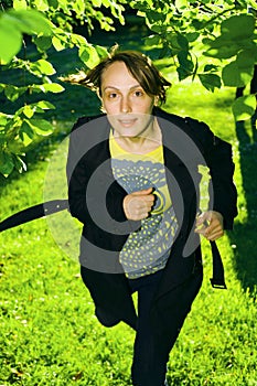 Young woman running in forest