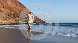 Young woman running on La Tejita beach, Tenerife , Spain