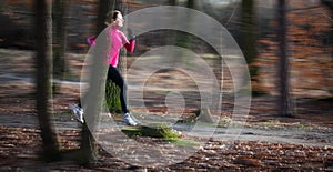 Young woman running outdoors in a city park