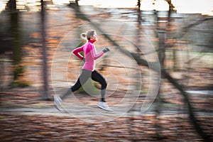 Young woman running outdoors in a city park