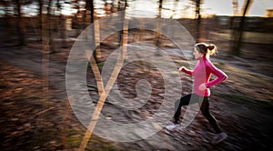 Young woman running outdoors in a city park