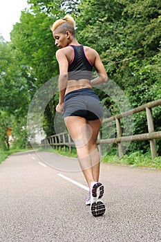 Young woman running outdoors photo