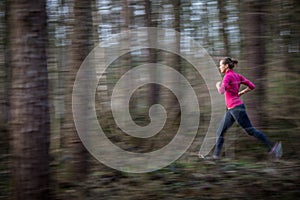 Young woman running outdoors in a forest
