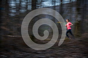 Young woman running outdoors in a forest