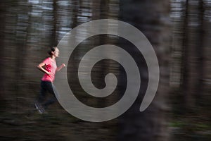 Young woman running outdoors in a forest