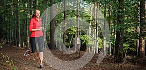 Young woman running outdoors in a forest