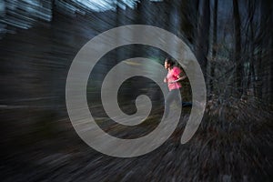 Young woman running outdoors in a forest