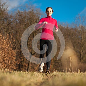 Young woman running outdoors on a lovely sunny day