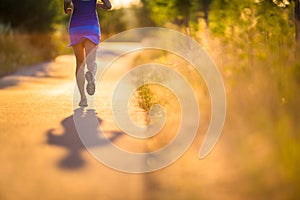 Young woman running outdoors on a lovely sunny summer evening