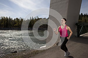 Young Woman Running Beside River