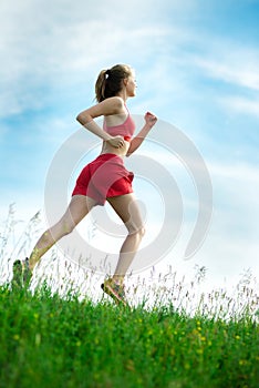 Young woman running summer park rural road