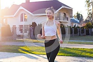 Young woman running at sunset on the