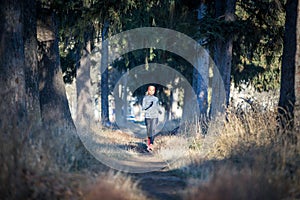 Young woman running training in autumn park