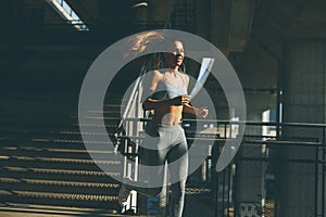 Young woman running in urban enviroment
