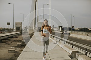 Young woman running in urban enviroment