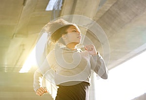 Young woman running in urban environment