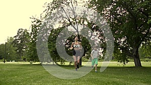 Young woman runs with her daughter. mom together with the child goes in for sports in the nature