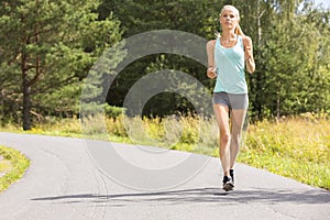 Young woman runs outdoor in the forest