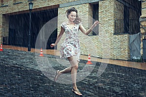 Young woman runs in the rain