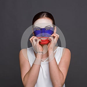 Young woman with Russian flag painted on her face